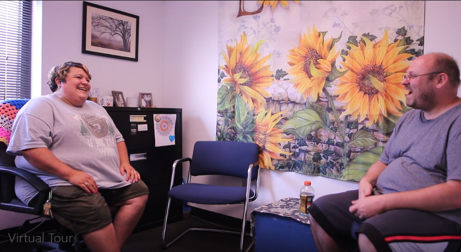 A Peoples Oakland member speaking with a counselor