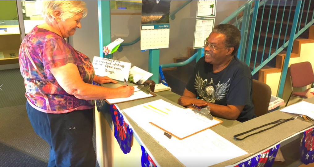 A Peoples Oakland member signing up for employment services and get resources