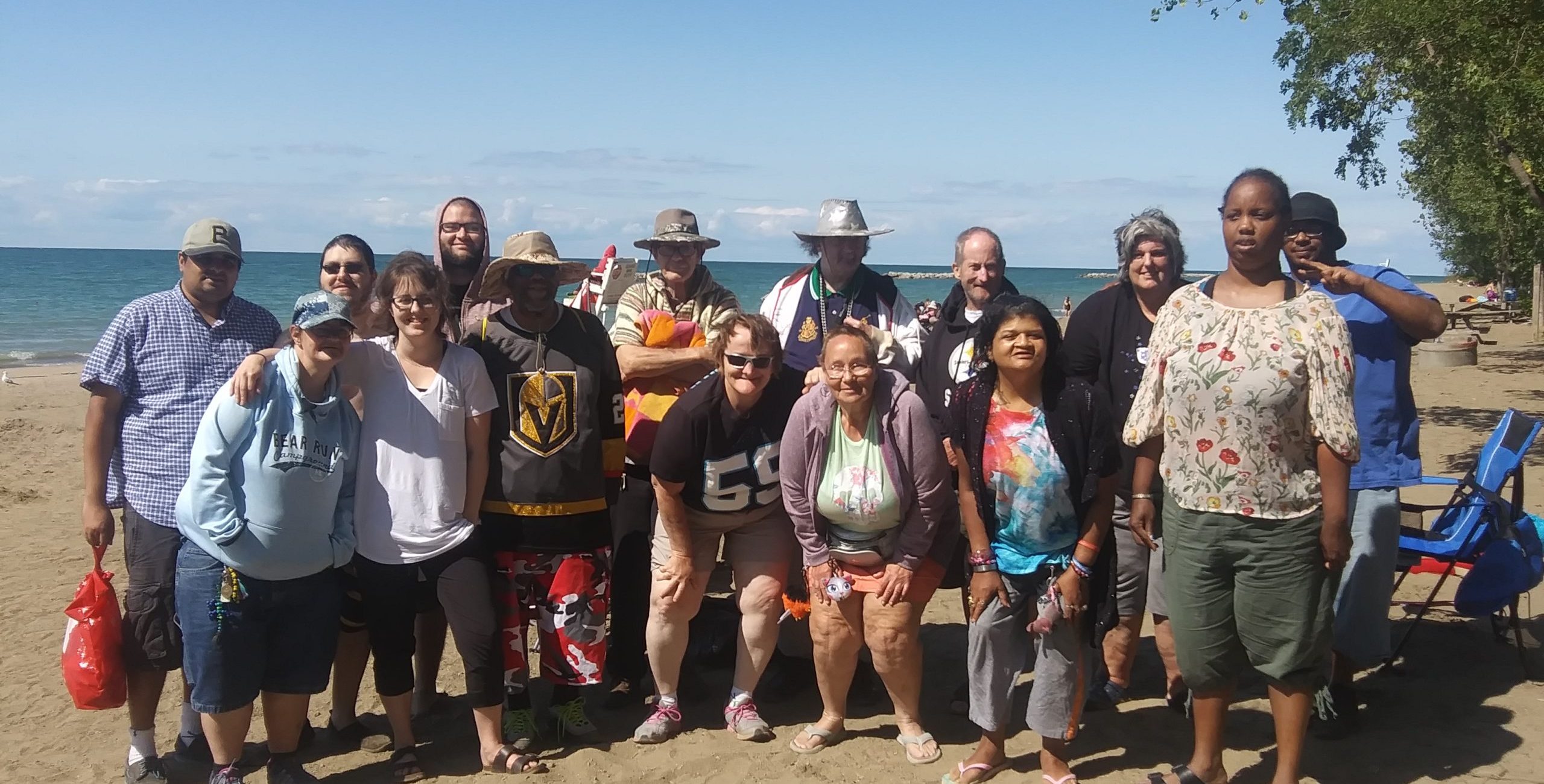 Peoples Oakland members posing as a group on the Lake Erie beach